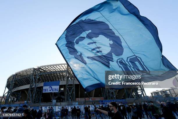 Flag with Diego Armando Maradona's face waving outside San Paolo Stadium on November 26, 2020 in Naples, Italy. Diego Armando Maradona died at 60...