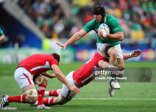 Stephen Ferris of Ireland is tackled by Sam Warburton and Dan Lydiate of Wales during quarter final one of the 2011 IRB Rugby World Cup between...