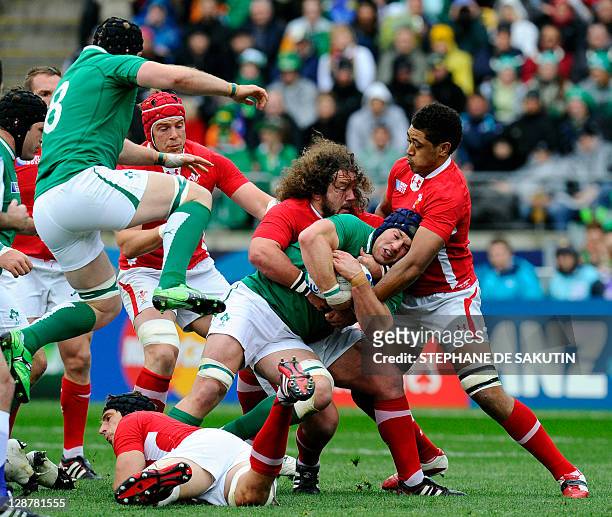 Ireland's flanker Sean O'Brien is tackled by Wales' prop Adam Jones and No8 Toby Faletau during the 2011 Rugby World Cup quarter-final match Ireland...