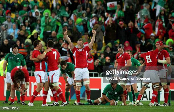 Wales players celebrate their team's 22-10 victory as the final whistle blows during quarter final one of the 2011 IRB Rugby World Cup between...