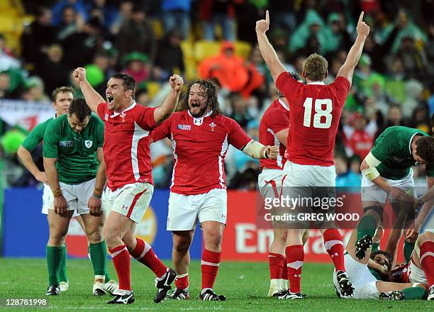Wales' hooker Huw Bennett , prop Adam Jones and Wales' Bradley Davies react next to Ireland's players after the 2011 Rugby World Cup quarter-final...