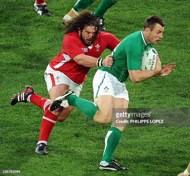 Ireland's right wing Tommy Bowe is tackled by Wales' prop Adam Jones during the 2011 Rugby World Cup quarter-final match Ireland vs Wales at the...