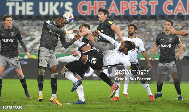 Moses Odubajo and Callum Paterson of Sheffield Wednesday clear the ball away as Kasey Palmer of Swansea City attempts a overhead kick during the Sky...