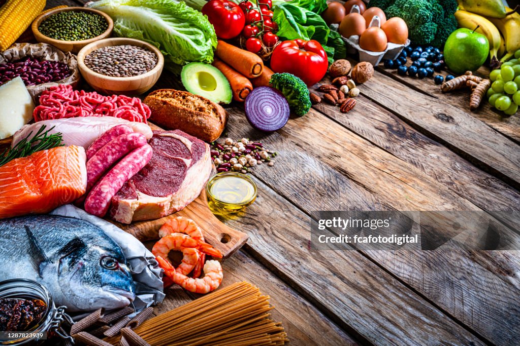 Group of healthy food on rustic wooden table. Copy space