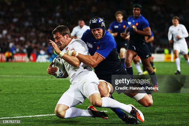 Mark Cueto of England is tackled by Julien Bonnaire of France during quarter final two of the 2011 IRB Rugby World Cup between England and France at...