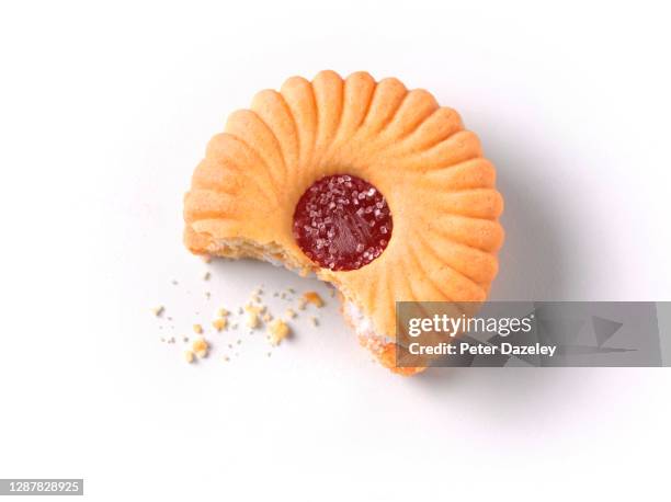 cookie with jam centre, half eaten, on white background - missing bite stock pictures, royalty-free photos & images
