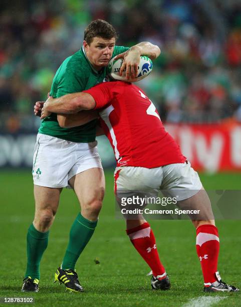 Brian O'Driscoll of ireland is tackled by Huw Bennett of Wales during quarter final one of the 2011 IRB Rugby World Cup between Ireland v Wales at...