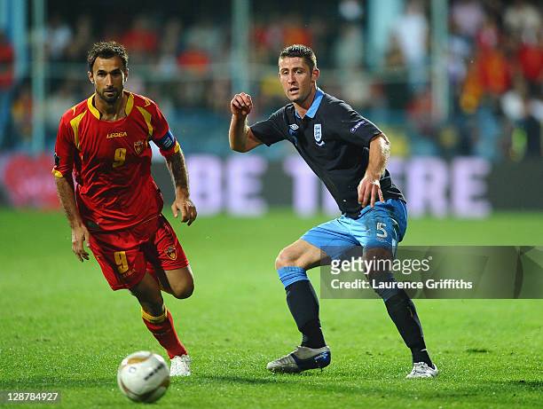 Gary Cahill of England battles with Mirko Vucinic of Montenegro during the UEFA EURO 2012 group G qualifier between Montenegro and England at the...