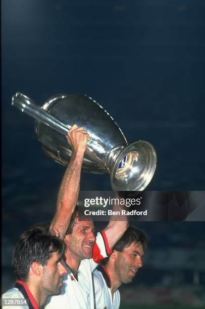 Franco Baresi of AC Milan holds the trophy aloft after their victory in the European Cup final against Benfica at Prater in Vienna, Austria. AC Milan...