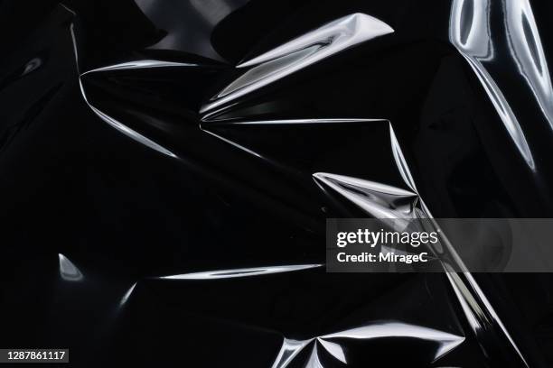 crumpled plastic foil reflecting white light - a reflection on a plastic cover stock pictures, royalty-free photos & images