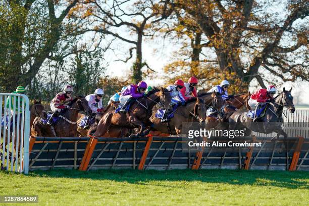 General view as runners clear a flight of hurdles at Taunton Racecourse on November 26, 2020 in Taunton, England. Owners are allowed to attend if...