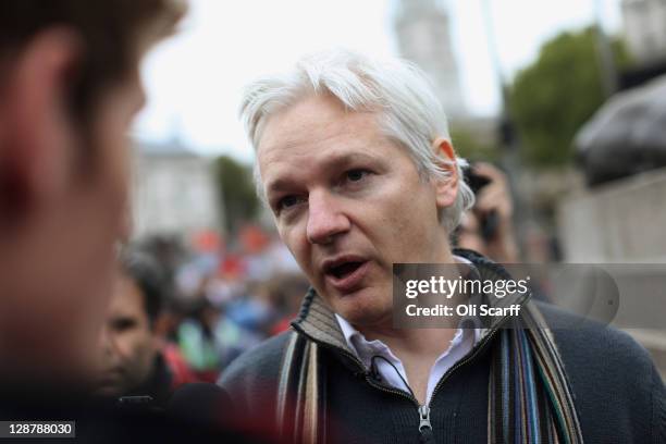 Julian Assange, founder of the WikiLeaks website, is interviewed as he leaves Trafalgar Square after addressing the crowd during the 'Antiwar Mass...