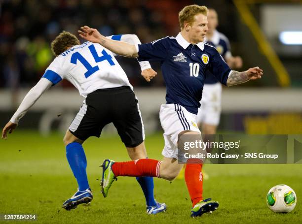 Scotland's Chris Burke speeds past Konstantin Vassiljev.