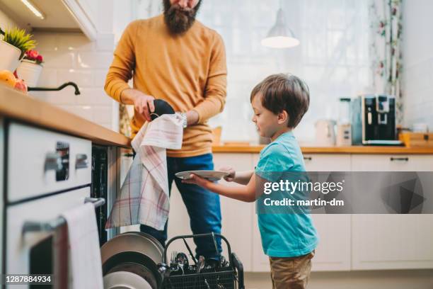 father and son doing the housework together - dishwasher stock pictures, royalty-free photos & images