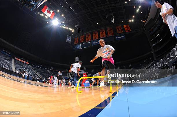 Kids doing drills with Armintie Price of the Atlanta Dream during the Dribble to Stop Diabetes Fit Clinic at Philips Arena on October 8, 2011 in...