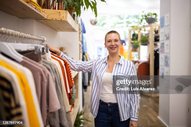 boutique owner in her store post pandemic lockdown - striped shirt stock pictures, royalty-free photos & images