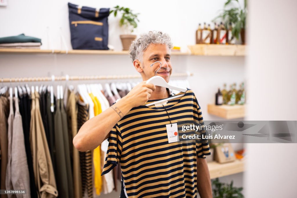 Male customer buying clothes at garment store