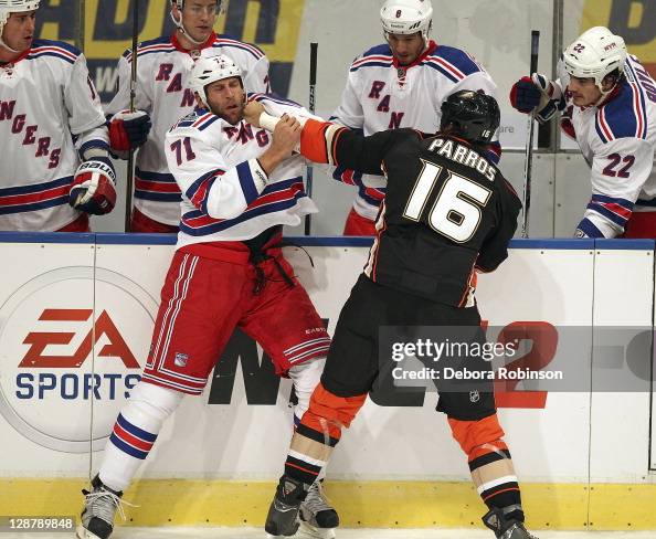 George Parros of the Anaheim Ducks fights with Mike Rupp of the New ...