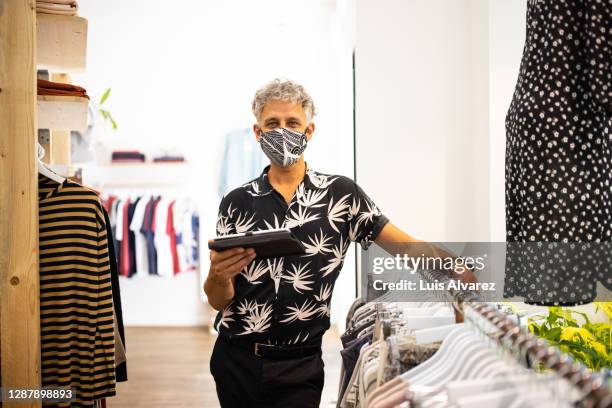 portrait of clothing store owner with face mask - reopening ceremony stock pictures, royalty-free photos & images