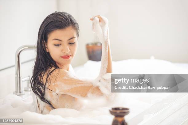 young asian woman bath with bubble in the bathtub at the bathroom. - japanese women bath stock-fotos und bilder
