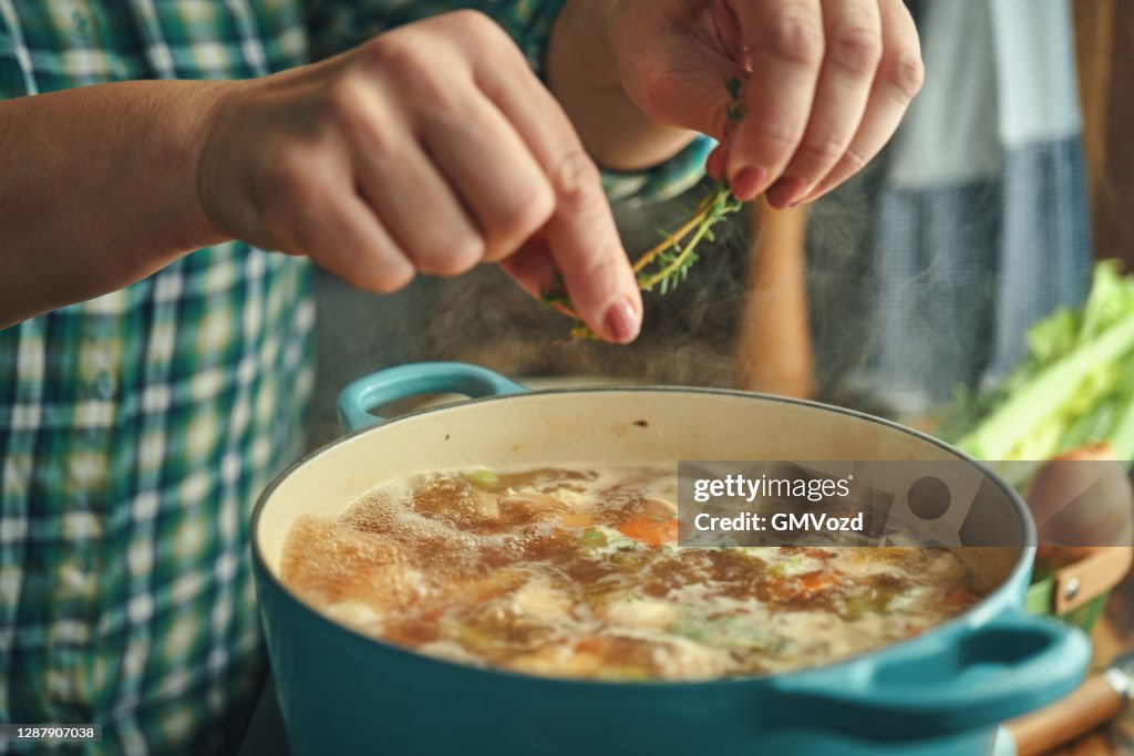 Preparing Chicken Noodles Soup with Fresh Vegetables