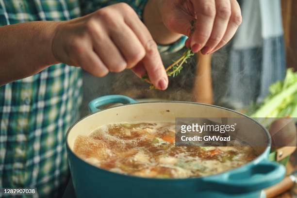 preparing chicken noodles soup with fresh vegetables - soup stock pictures, royalty-free photos & images