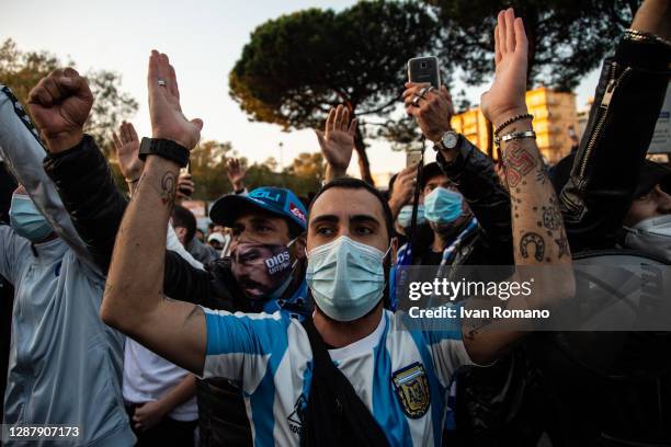 Supporters are singing chants during the mourning of the death of soccer player Diego Armando Maradona at the San Paolo stadium on November 26, 2020...