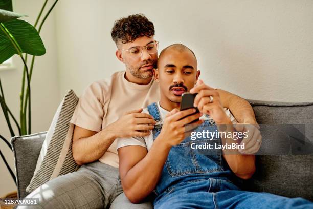 should we just stay in and just order online? - gay man stock pictures, royalty-free photos & images