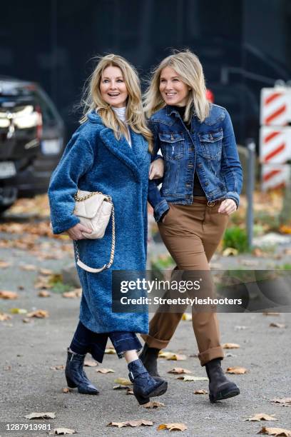 German TV host Frauke Ludowig wearing a long blue coat by Semperlei, a white turtleneck pullover by Semperlei, dark blue ankle booties with snake...