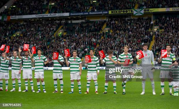 V ABERDEEN .CELTIC PARK - GLASGOW.Celtic players hold up cards promoting Show Bigotry the Red Card