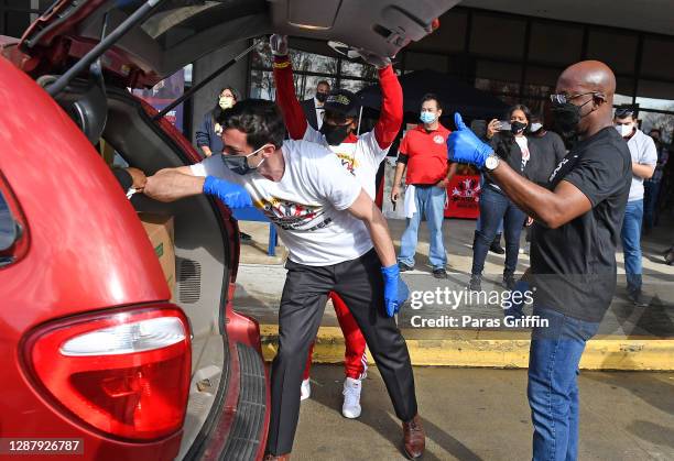 Jon Ossoff. Lil Bankhead, and Raphael Warnock attend Hosea Helps Thanksgiving Dinner Drive Thru at Georgia World Congress Center on November 26, 2020...