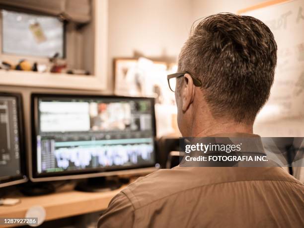 male video editor working at home - film editor stock pictures, royalty-free photos & images