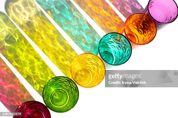 multicolor drink glasses with shadow on white  background, isolated. - alcohol top view stock-fotos und bilder