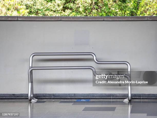 modern design stainless metal pipes bench in subway station by a white wall - metro medellin stock pictures, royalty-free photos & images