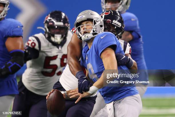 Matthew Stafford of the Detroit Lions is sacked by Nate Hall of the Houston Texans during the second half of a game at Ford Field on November 26,...