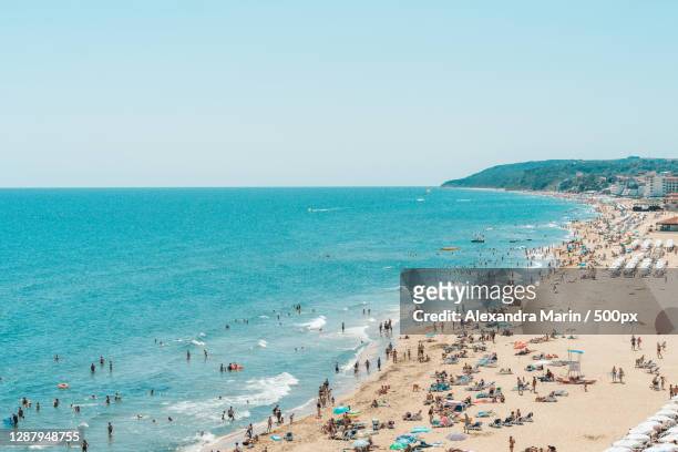 people at beach against clear sky,obzor,bulgaria - bulgarije stockfoto's en -beelden