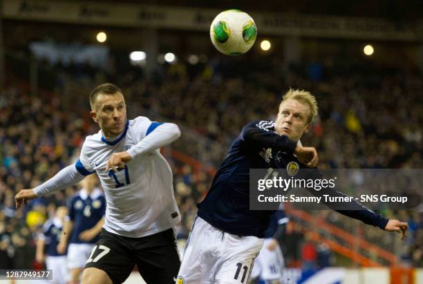 Scotland's Steven Naismith and Enar Jaager challenge for the ball.