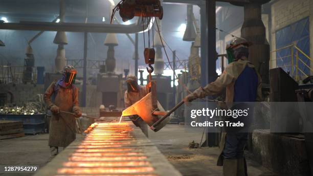 metal industry work - pouring molten metal - foundry worker stock pictures, royalty-free photos & images