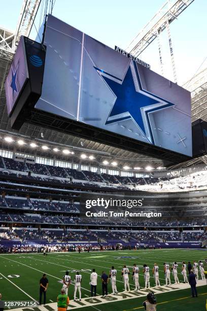 Dallas Cowboys are seen during the national anthem prior to facing the Washington Football Team at AT&T Stadium on November 26, 2020 in Arlington,...