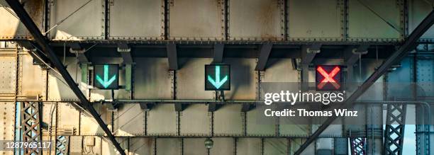 digital traffic arrows on a bridge - red x stock pictures, royalty-free photos & images