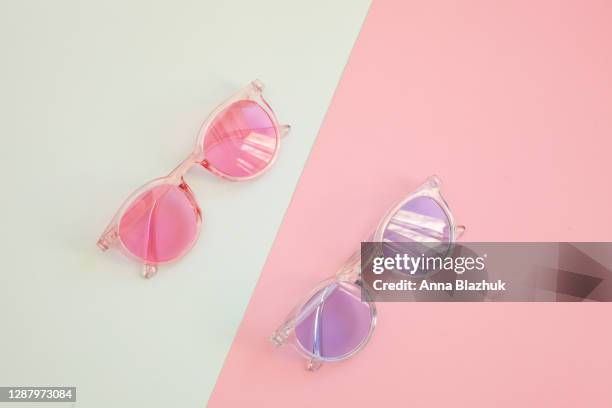 colorful summer blue and pink trendy sunglasses over diagonal paper background. top view. - sunglasses stock pictures, royalty-free photos & images