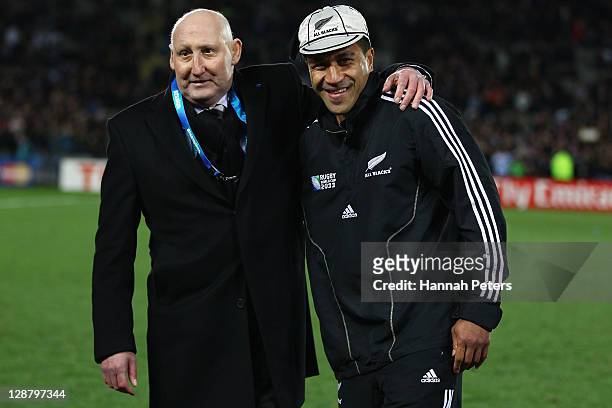 Former All Black's captain and NZRU Chairman Jock Hobbs presents Mils Muliaina of the All Blacks with his 100th test cap during quarter final four of...