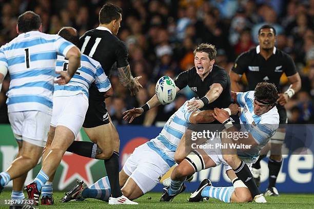 Colin Slade of the All Blacks is tackled shortly before being replacced during quarter final four of the 2011 IRB Rugby World Cup between New Zealand...