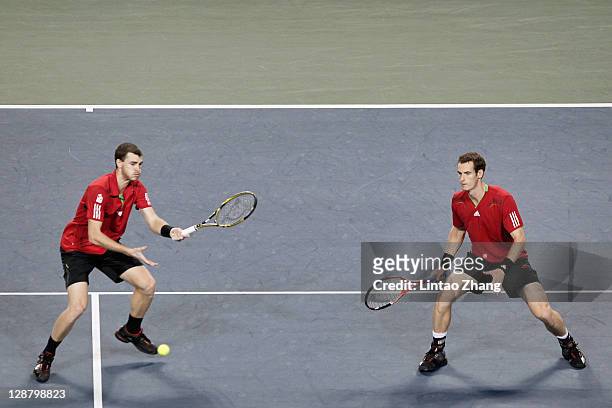 Andy Murray of Great Britain with Jamie Murray return a shot to Frantisek Cermak of Czech Republic and Filip Polasek of Slovakia in man doubles final...