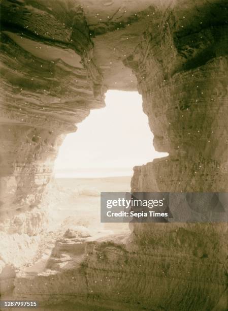 Dead Sea Scrolls and caves and Qumran Excavations of Essene Monastery. View looking out from entrance to cave no. 4. 1947, West Bank, Qumran Site.