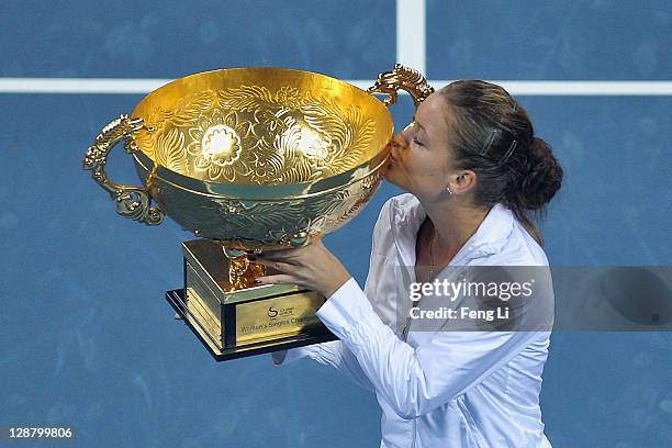 Agnieszka Radwanska of Poland pose for photographers after winning against Andrea Petkovic of Germany in the women's final of the China Open at the...