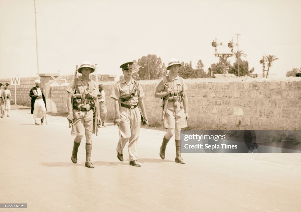 Haifa, result of terrorist acts and government measures. H.M.S. Two marines with one British Police patrolling Nazareth Street. 1938, Israel, Haifa