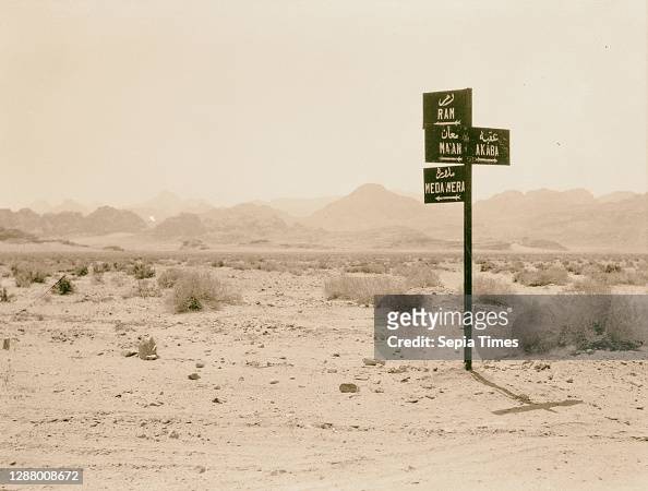 Traffic sign near Ibn Saoud boundary, indicating direction to Wadi Rum, Medawera, Ma'an & Akaba.