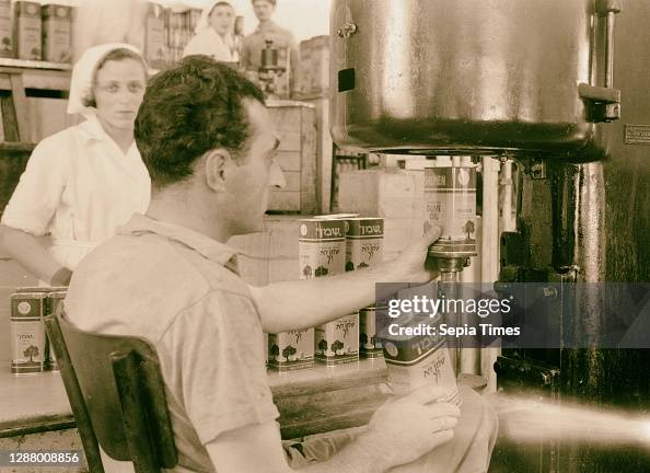 Jewish factories in Palestine on Plain of Sharon & along the coast to Haifa 'Shemen' oil works. Filling the tins with oil by automatic machinery. 1939, Israel, Haifa