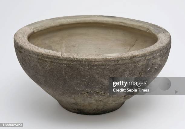 Gray bowl on small standing surface, curved upper edge.